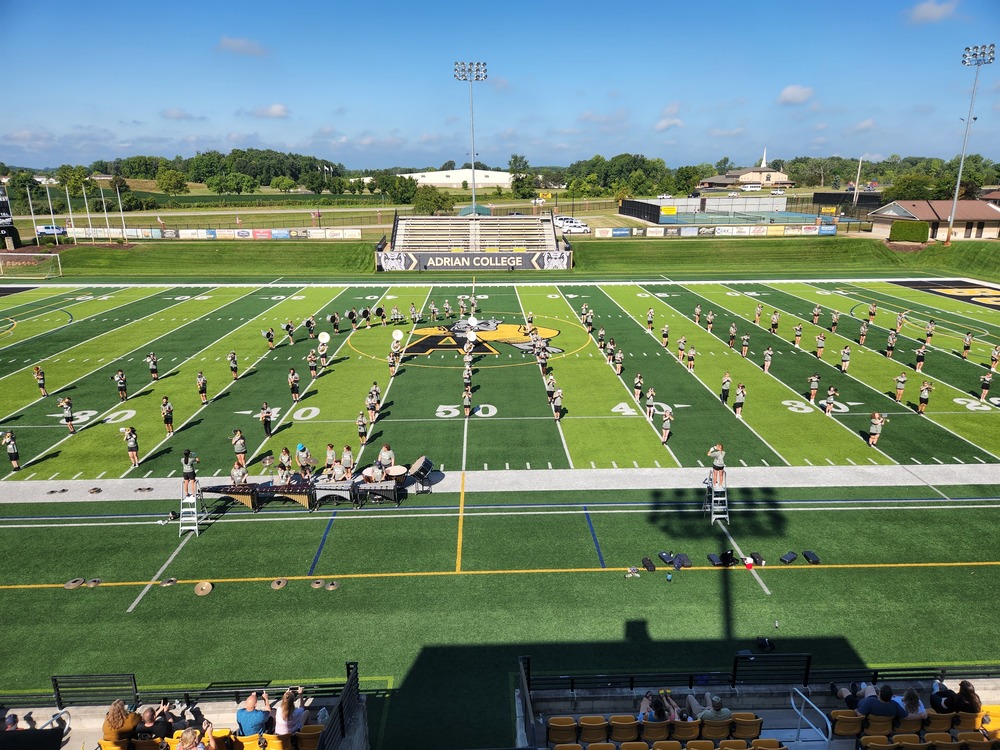 Fenton marching band students at Adrian College on their football field practicing for the upcoming season.